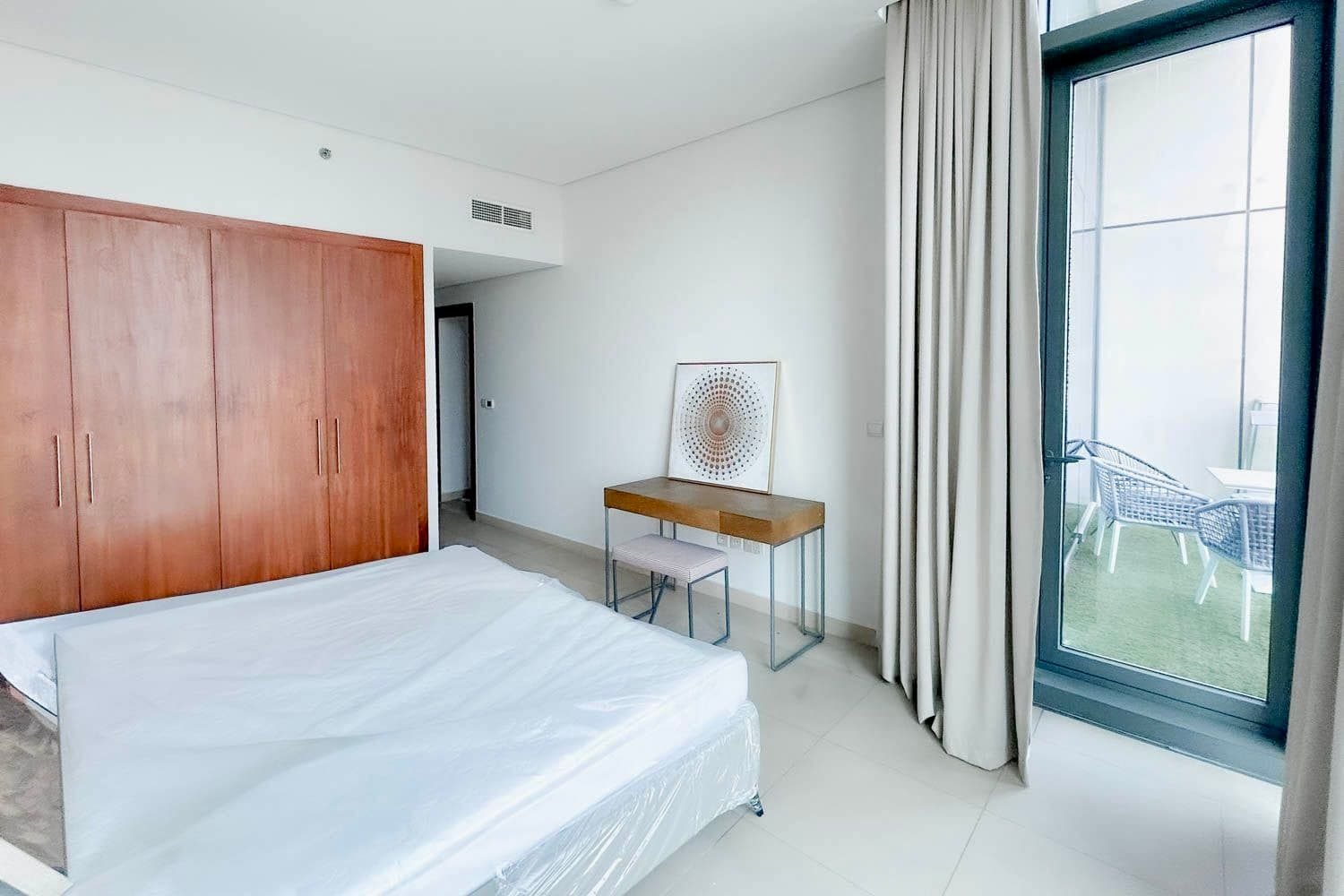 Bedroom with Emaar tower view through floor-to-ceiling window