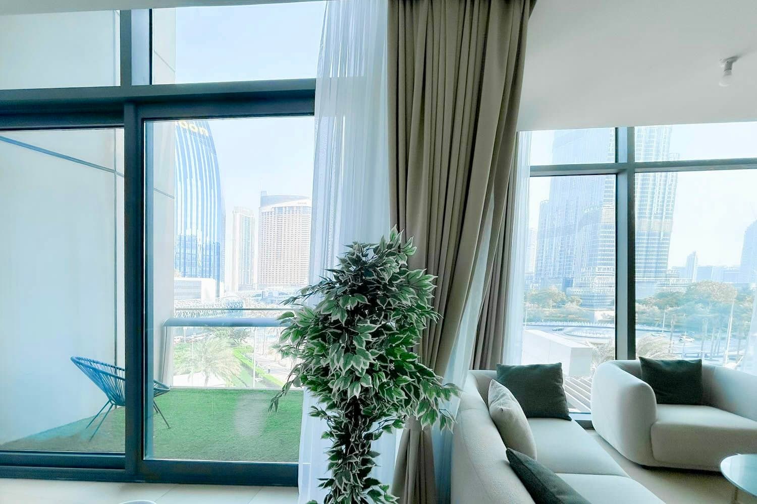 Main living room with dining area and floor-to-ceiling windows